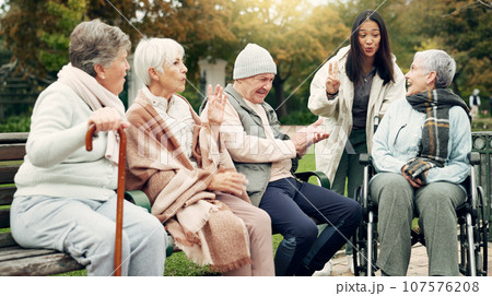 Friends, happy and senior people in park for bonding, conversation and quality time together outdoors. Friendship, retirement and elderly man and women with caregiver on bench for relaxing in nature Friends, happy and senior people in park for bonding, conversation and quality time together outdoors. Friendship, retirement and elderly man and women with caregiver on bench for relaxing in nature 107576208