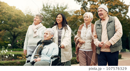 Friends, walking and elderly people in park for bonding, wellness and quality time together outdoor. Friendship, health and senior man and women with caregiver in nature for fresh air, calm and relax Friends, walking and elderly people in park for bonding, wellness and quality time together outdoor. Friendship, health and senior man and women with caregiver in nature for fresh air, calm and relax 107576329
