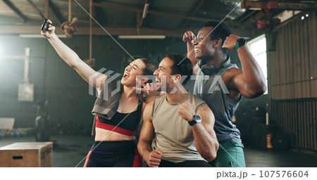 Selfie, teamwork and fitness with friends at gym for social media, workout and health. Support, profile picture and wellness with people and training for smile, photography and exercise together 107576604