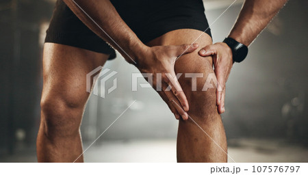 Fitness, knee pain and hands of man at gym for training with muscle, problem or arthritis. Sports, injury and leg of male athlete with joint massage for fibromyalgia, osteoporosis or bone accident 107576797
