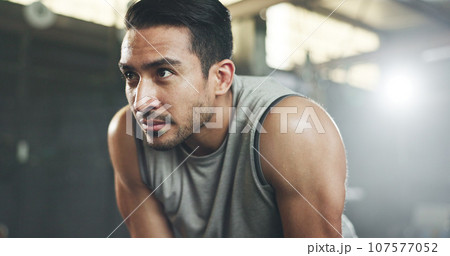 Sweat, fitness and man tired from gym, workout or rest in training in cardio, sports and body builder breathing with fatigue. Exhausted, break and athlete with commitment for health challenge 107577052