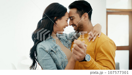 Couple, forehead touch and hug in living room with love, bonding and happy people together at home. Healthy relationship, trust and support in commitment, partner and dancing, romance and intimacy Couple, forehead touch and hug in living room with love, bonding and happy people together at home. Healthy relationship, trust and support in commitment, partner and dancing, romance and intimacy 107577301