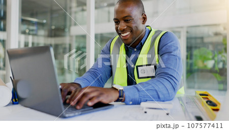 Laptop, design and a black man construction worker in an office for planning a building project. Computer, smile and a happy young engineer in the workplace for research as a maintenance contractor Laptop, design and a black man construction worker in an office for planning a building project. Computer, smile and a happy young engineer in the workplace for research as a maintenance contractor 107577411