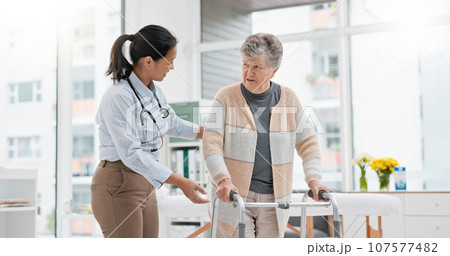 Physical therapy, walker or doctor nursing old woman in retirement or hospital for wellness or support. Exercise, caregiver helping or elderly patient learning with walking frame in rehabilitation Physical therapy, walker or doctor nursing old woman in retirement or hospital for wellness or support. Exercise, caregiver helping or elderly patient learning with walking frame in rehabilitation 107577482