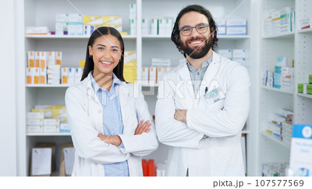 Crossed arms, pharmacy and portrait of people with smile for medical care, service and healthcare. Professional, teamwork and man and woman pharmacist for medication, medicine and clinic dispensary 107577569