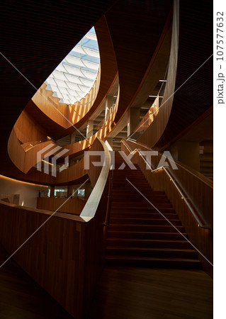 Design of the central public library in Calgary. Modern art interior design with wooden walls and glass ceiling. Design of the central public library in Calgary. Modern art interior design with wooden walls and glass ceiling. 107577632