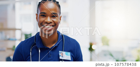 Black man, doctor and smile on face in clinic for healthcare services, excited or happy for job. African medic, male nurse and happiness in portrait for wellness service, medical career or workplace Black man, doctor and smile on face in clinic for healthcare services, excited or happy for job. African medic, male nurse and happiness in portrait for wellness service, medical career or workplace 107578438