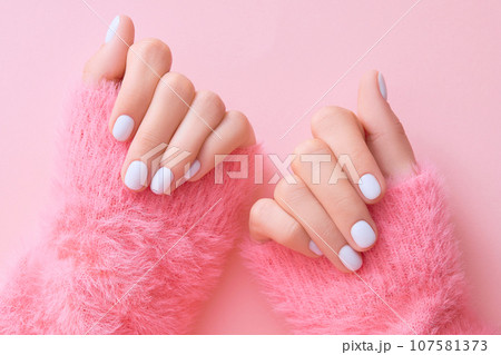 Close up womans hands with white manicure 107581373