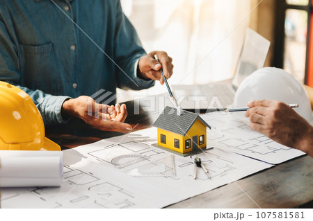 Engineer teams meeting working together wear worker helmets hardhat on construction site in modern city.Asian industry professional team 107581581