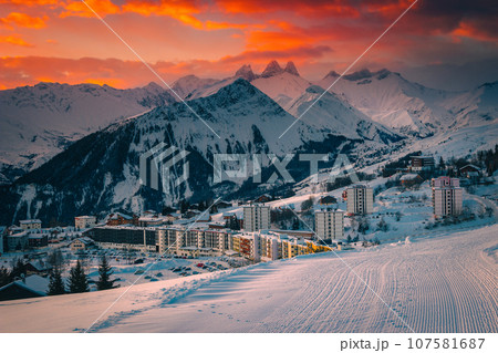 Alpine ski resort with buildings at sunrise, La Toussuire, France Alpine ski resort with buildings at sunrise, La Toussuire, France 107581687