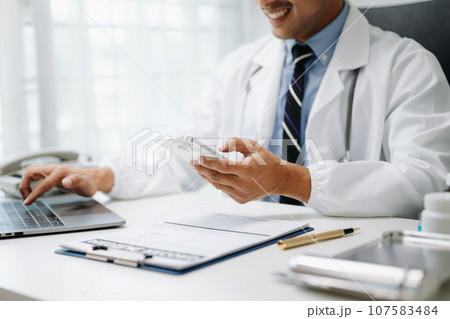 Medical technology concept. Doctor working with mobile phone and stethoscope in office.. 107583484