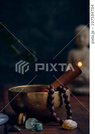 tibetan bowl with rosary beads 107584784