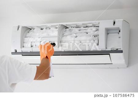 air conditioner cleaning with spray foam cleaner 107586475
