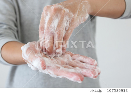 Man wash hands with soap for COVID-19 corona virus prevention concept Man wash hands with soap for COVID-19 corona virus prevention concept 107586958