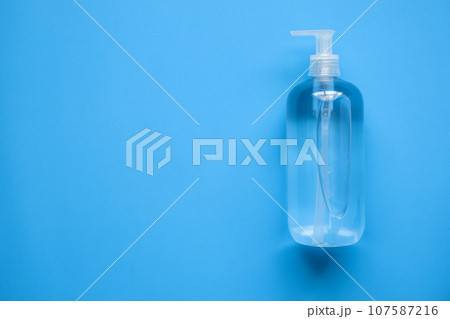 Alcohol hand sanitizer gel bottle on blue background protection against COVID-19 coronavirus. Healthcare and medical concept Alcohol hand sanitizer gel bottle on blue background protection against COVID-19 coronavirus. Healthcare and medical concept 107587216