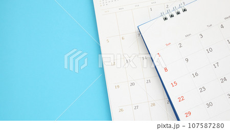 calendar page close up on blue background business planning appointment meeting concept calendar page close up on blue background business planning appointment meeting concept 107587280