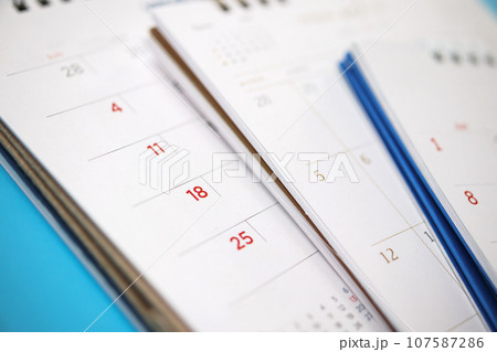 calendar page close up on blue background business planning appointment meeting concept calendar page close up on blue background business planning appointment meeting concept 107587286