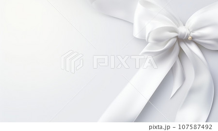 A digital image of a white ribbon bow with a pearl in the center, tied in a classic style with two loops and two tails. The bow is made of a silky material and has a pointed end. The background is a A digital image of a white ribbon bow with a pearl in the center, tied in a classic style with two loops and two tails. The bow is made of a silky material and has a pointed end. The background is a 107587492