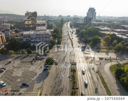Aerial drone Shot of street Marathon in Skopje, Republic of North Macedonia. Crowd of running people on the city streets Aerial drone Shot of street Marathon in Skopje, Republic of North Macedonia. Crowd of running people on the city streets 107588884