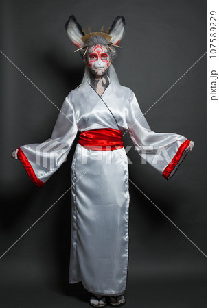 Beautiful model woman wearing Halloween mask on black background. Halloween makeupconcept 107589229