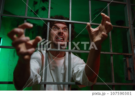 Mentally unstable male patient with attack of rabies locked in cage ward Mentally unstable male patient with attack of rabies locked in cage ward 107590301