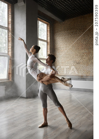 Artists graceful dance movement, ballet dancers performing beautiful action 107590399