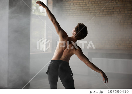 Handsome shirtless man ballet dancer making dance element Handsome shirtless man ballet dancer making dance element 107590410