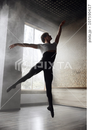 Young stylish modern male ballet dancer in motion Young stylish modern male ballet dancer in motion 107590417