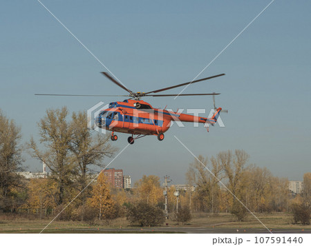 An emergency helicopter is taking off from city helicopter's pad. An emergency helicopter is taking off from city helicopter's pad. 107591440
