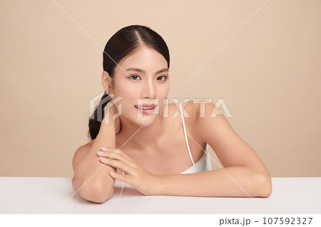 Beautiful young asian woman with clean fresh skin on beige background, Face care, Facial treatment, Cosmetology, beauty and spa, Asian women portrait. Beautiful young asian woman with clean fresh skin on beige background, Face care, Facial treatment, Cosmetology, beauty and spa, Asian women portrait. 107592327