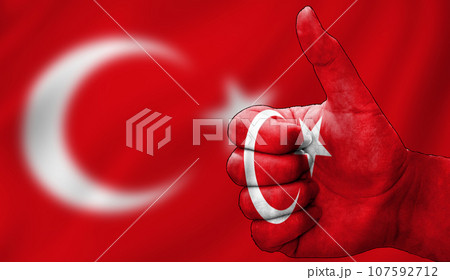 thumbs up in approval with the Turkish flag painted 107592712