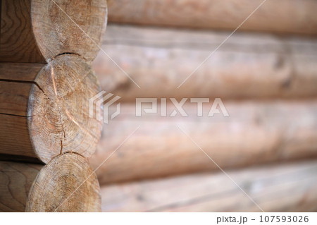 Natural background pattern of log wall. Construction of houses made of wood, rounded timber 107593026