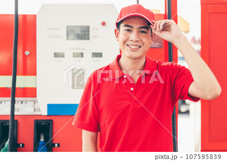 Portrait Gas station service staff Asian male worker happy smiling working car gasoline refill service job. 107595839