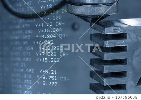 Abstract scene the wire EDM machine cutting the mold insert parts and G-code data background. Abstract scene the wire EDM machine cutting the mold insert parts and G-code data background. 107596038