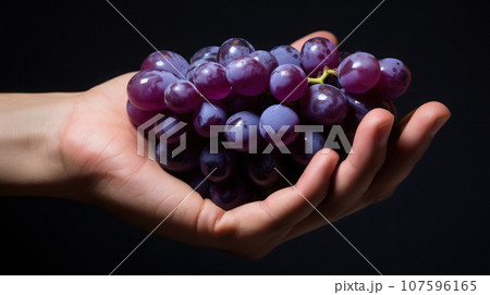 Hand holding a grape 107596165