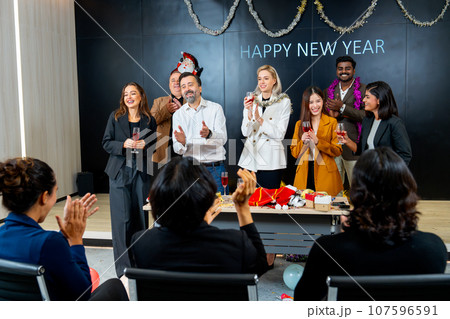 Caucasian business man stand on stage with his staffs to say or bless or encourage the employee Caucasian business man stand on stage with his staffs to say or bless or encourage the employee 107596591