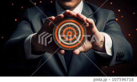 Business man holding darts board 107596718
