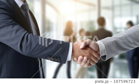 close-up businessman meeting and handshaking in the white office 107596723