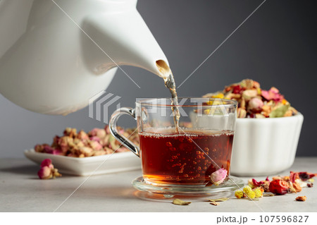 Herbal tea is poured into a mug. 107596827