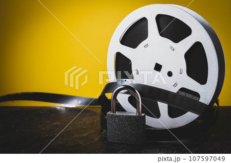 Old film. Cinema on reel. Analog cinema. Movie on cassette. Old film. Cinema on reel. Analog cinema. Movie on cassette. 107597049