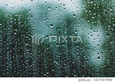 Sun after rain. Drops on glass. It's been raining. Texture on glass. 107597069