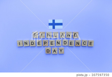 December 6, Independence Day of Finland, flag of Finland, minimalistic banner with the inscription in wooden letters on a blue background 107597350
