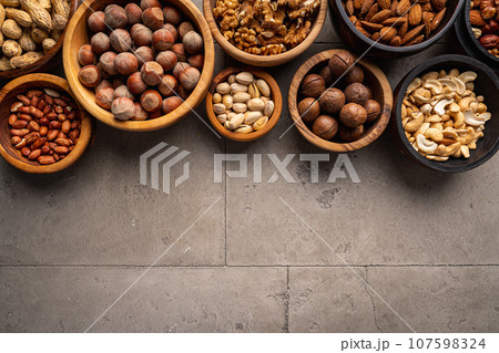 Assortment of nuts in bowls 107598324