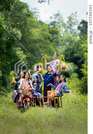 Vertical image of Asian young teenage girls sit on motorcycle sidecar with smiling Vertical image of Asian young teenage girls sit on motorcycle sidecar with smiling 107598381