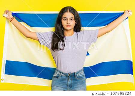 Indian woman holds Israel national flag showing protest against war, hoping for success and win Indian woman holds Israel national flag showing protest against war, hoping for success and win 107598824