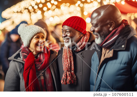 Multiracial senior friends having fun And walk around Christmas fair in festively decorated city 107600511