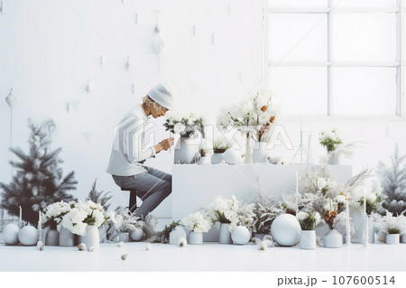 Attractive man florist creating natural Christmas winter decor in flower shop. Small business 107600514