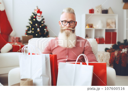 Attractive bearded man with lots of gifts for loved ones after Christmas shopping 107600516
