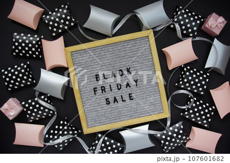 The inscription - black Friday sale in a frame, there are shopping boxes around 107601682