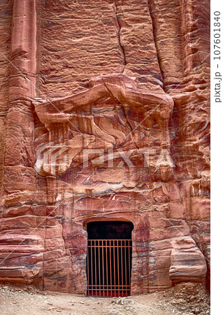 View of the Temples and caves carved into the sandstone rock in the gorge. Petra, Jordan 107601840